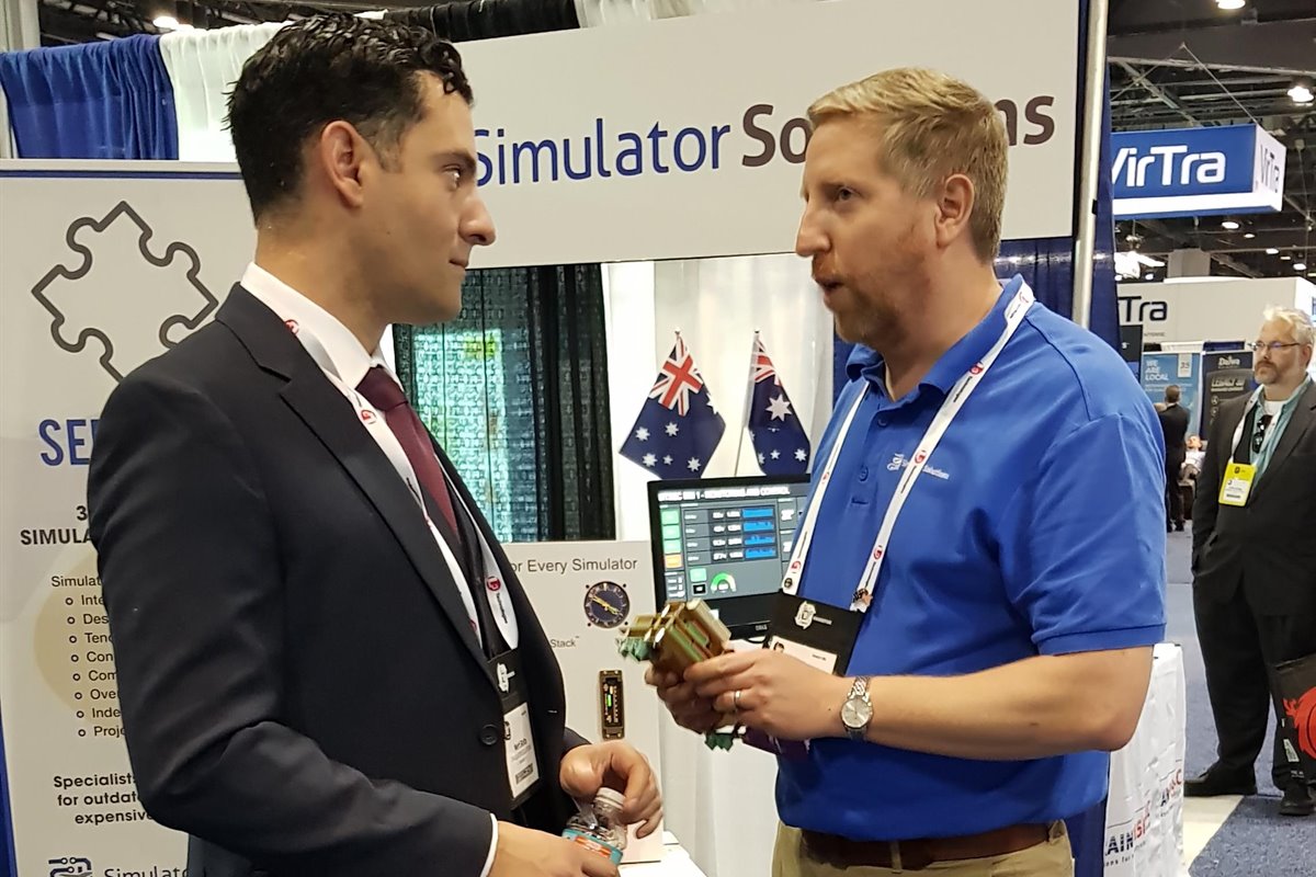 Simulator Solutions consulting with a client at a trade show