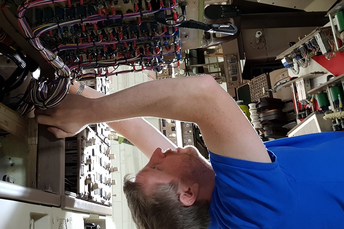 Technician servicing a simulator wiring loom